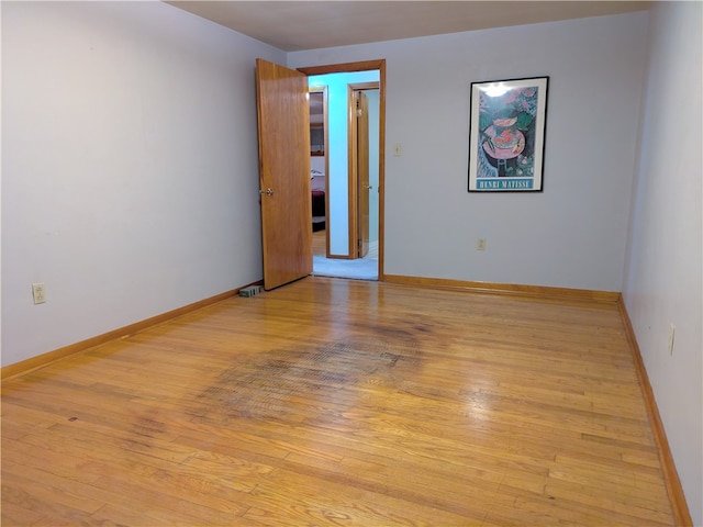 empty room with light hardwood / wood-style flooring