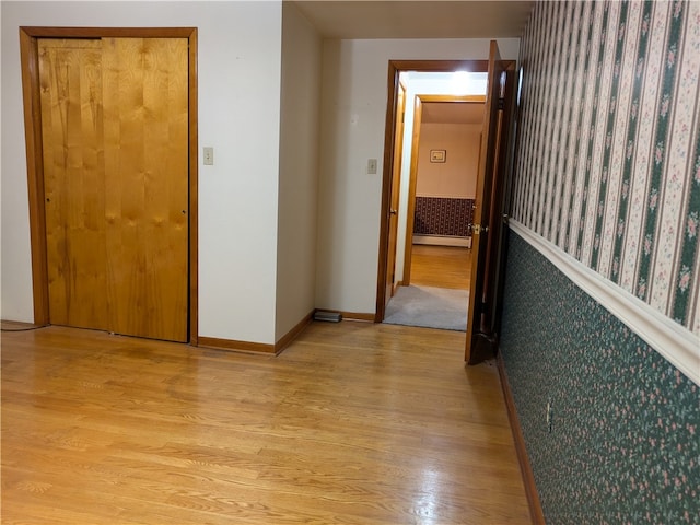 hallway featuring a baseboard radiator and light wood-type flooring