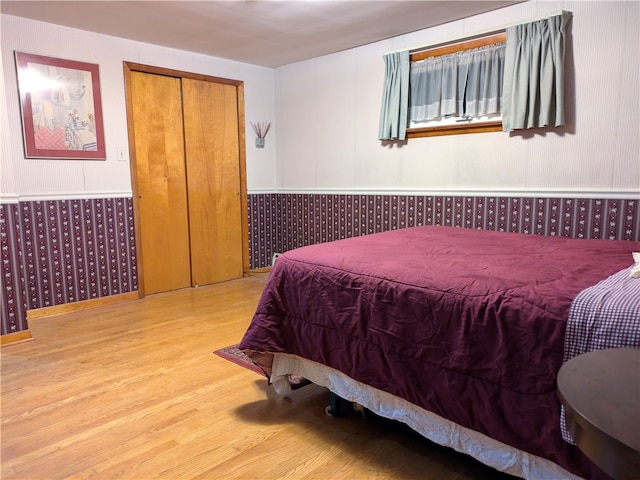 bedroom with hardwood / wood-style flooring and a closet