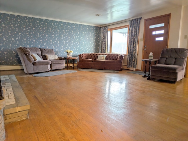 living room featuring crown molding and light hardwood / wood-style floors