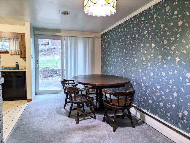 dining room featuring crown molding and light carpet