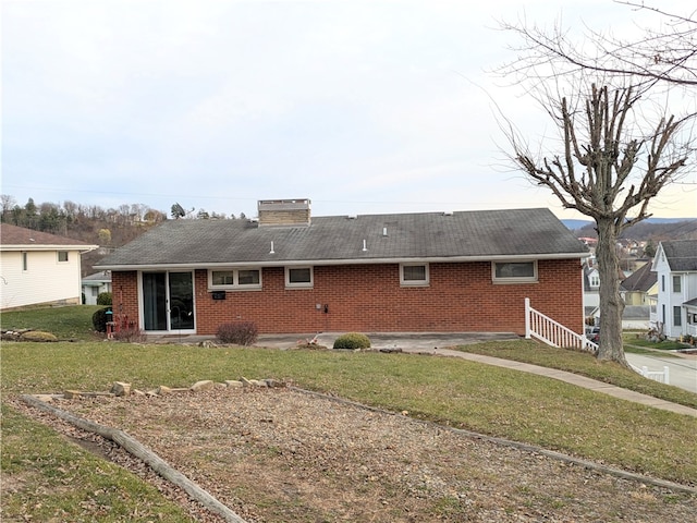 back of house featuring a yard and a patio