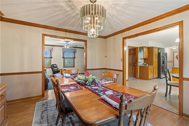 dining area featuring ceiling fan with notable chandelier, light wood-type flooring, and ornamental molding