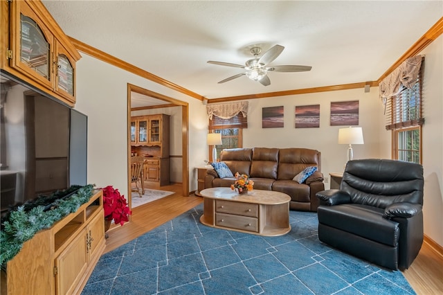 living room featuring ceiling fan, dark wood-type flooring, and ornamental molding