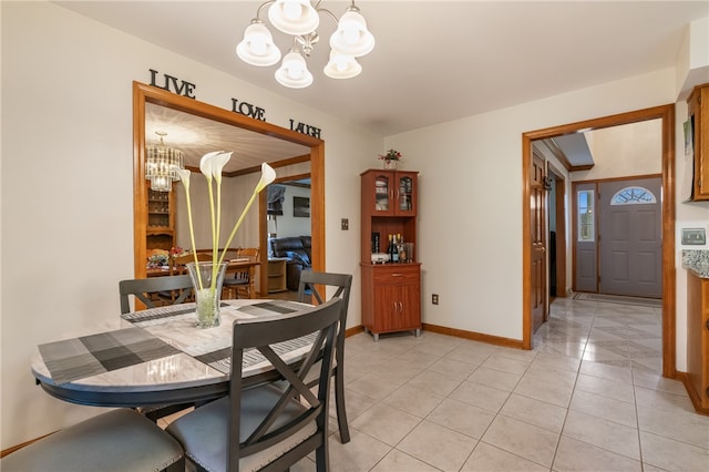 dining room featuring a chandelier and light tile patterned floors