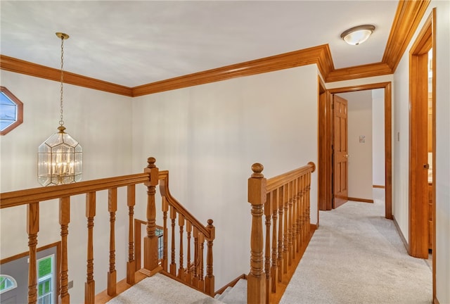 corridor with light carpet, crown molding, and an inviting chandelier