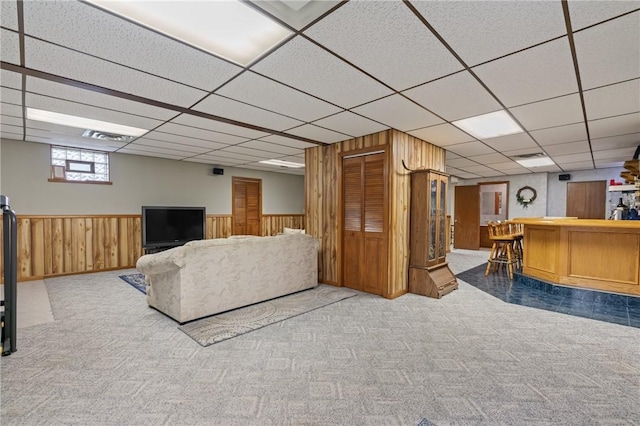 104 Caromar Dr, Adams Twp, PA 16046 - living room with bar area, a drop ceiling, carpet floors, a wainscoted wall, and wooden walls