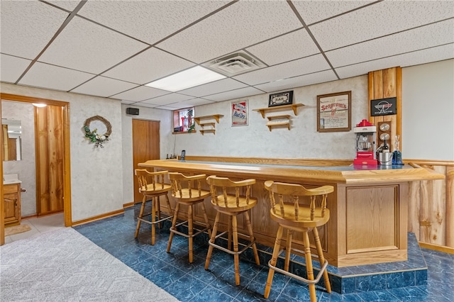 bar featuring a paneled ceiling