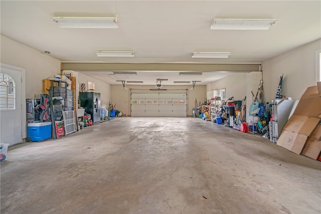 garage with stainless steel refrigerator with ice dispenser