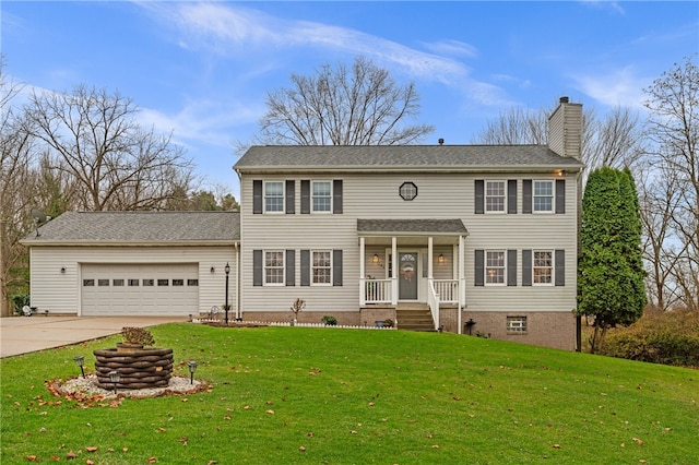 colonial home featuring a garage and a front lawn