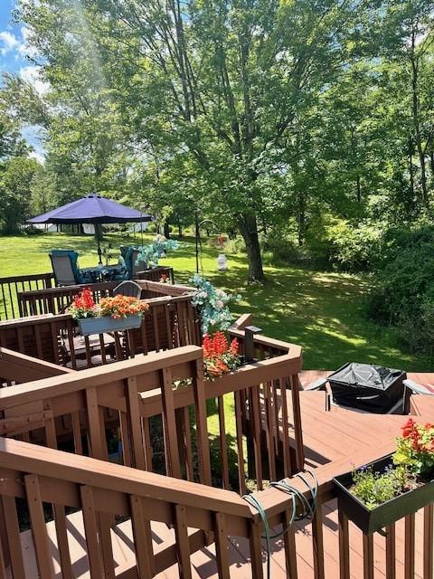 104 Caromar Dr, Adams Twp, PA 16046 - wooden deck featuring outdoor dining area, a lawn, and view of scattered trees