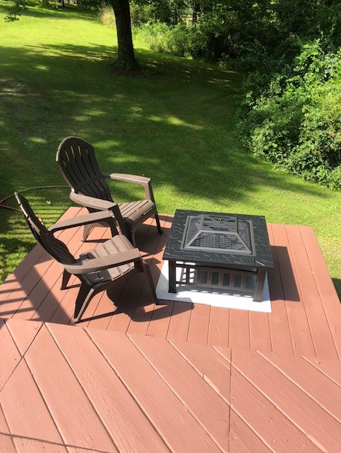 wooden terrace featuring a lawn