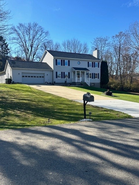 view of front of home featuring a front lawn and a garage