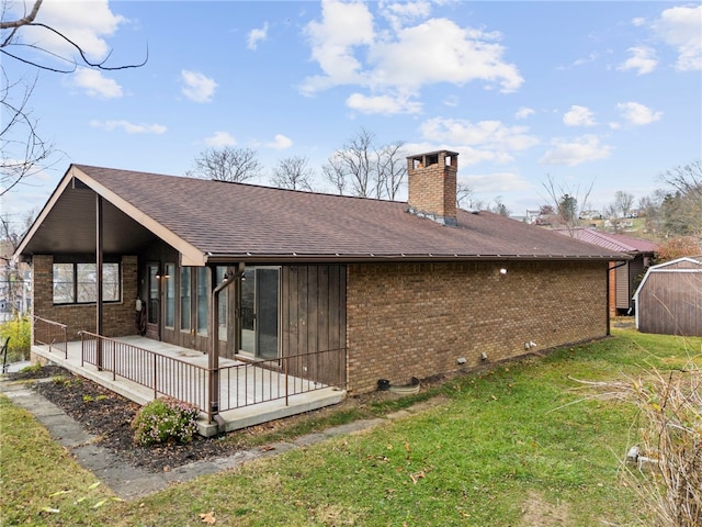 rear view of property with a yard