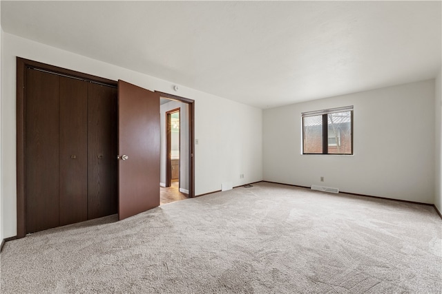 unfurnished bedroom with light colored carpet