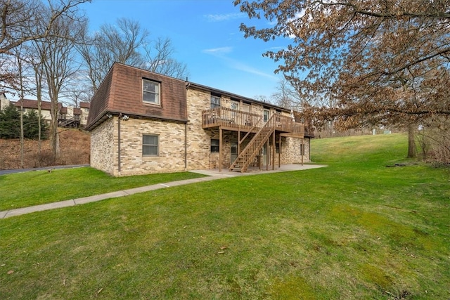 back of property featuring a yard and a wooden deck