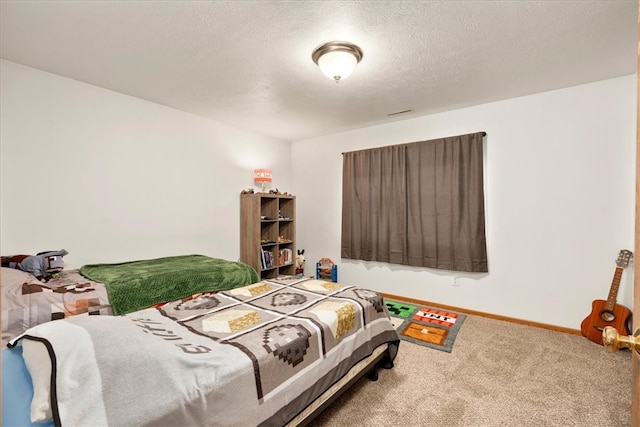 carpeted bedroom with a textured ceiling