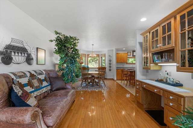 living room featuring light hardwood / wood-style flooring and a chandelier