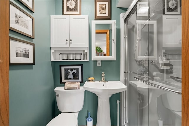 bathroom featuring an enclosed shower and toilet