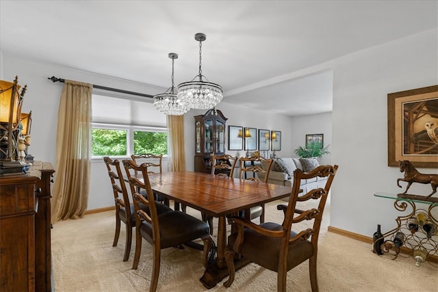 carpeted dining room featuring a notable chandelier