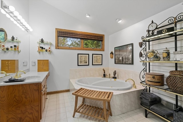 bathroom featuring tile patterned floors, vanity, tiled bath, and vaulted ceiling