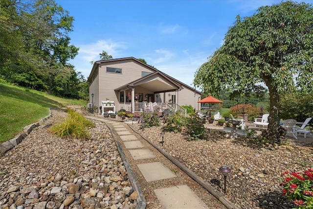 back of property featuring a porch