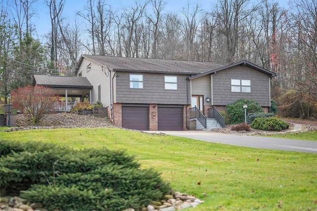 raised ranch featuring a front yard and a garage