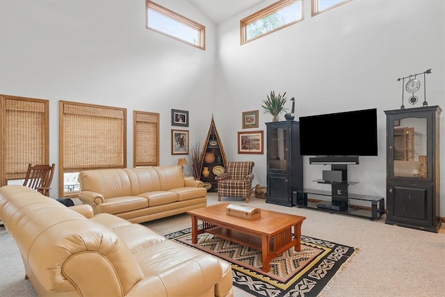 living room featuring carpet floors and high vaulted ceiling