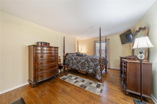 bedroom with dark wood-type flooring