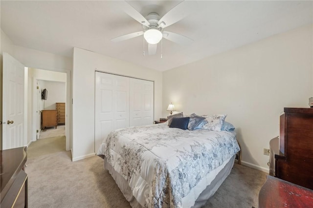 carpeted bedroom featuring a closet and ceiling fan