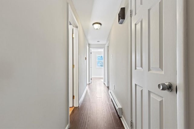 hallway featuring dark hardwood / wood-style flooring and a baseboard heating unit