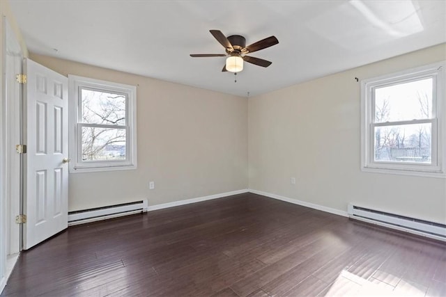 unfurnished room featuring ceiling fan, dark hardwood / wood-style flooring, and a baseboard heating unit