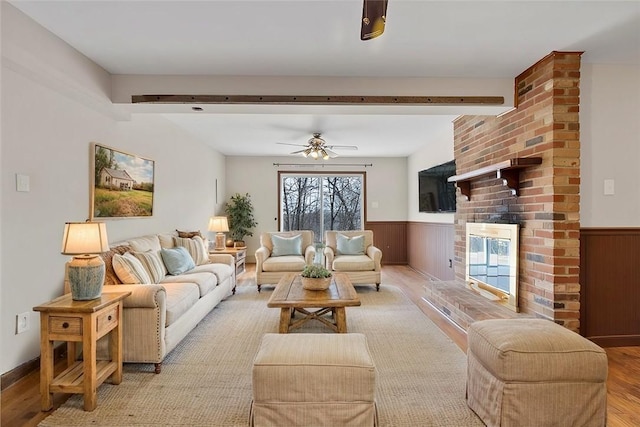 living room with ceiling fan and light wood-type flooring