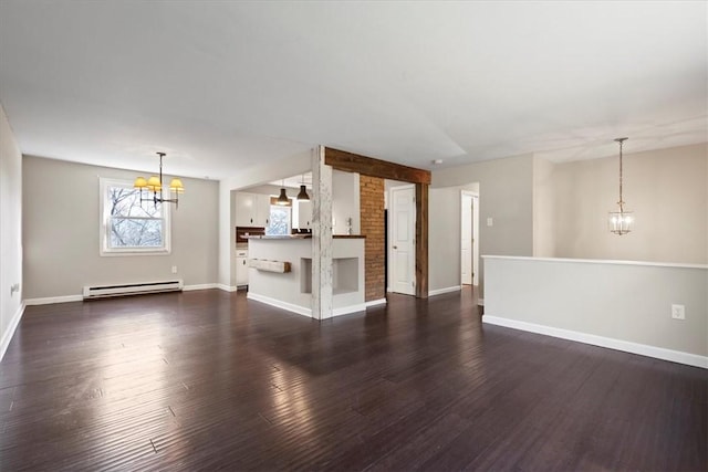 unfurnished living room with dark hardwood / wood-style floors, a baseboard radiator, and a chandelier