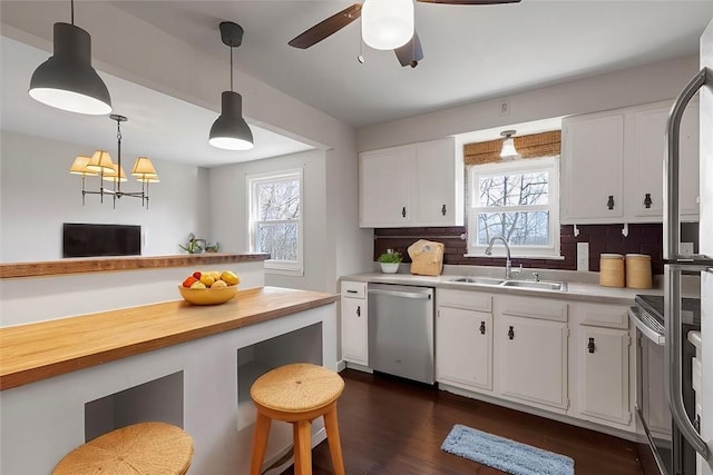 kitchen featuring sink, white cabinetry, stainless steel appliances, and tasteful backsplash