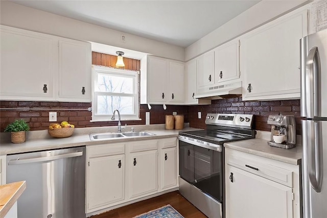 kitchen featuring white cabinets, backsplash, sink, and stainless steel appliances