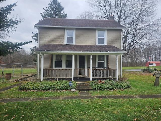 view of front property featuring covered porch and a front yard