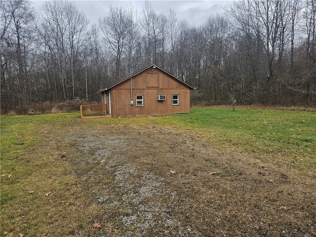 view of home's exterior with a yard and an outbuilding