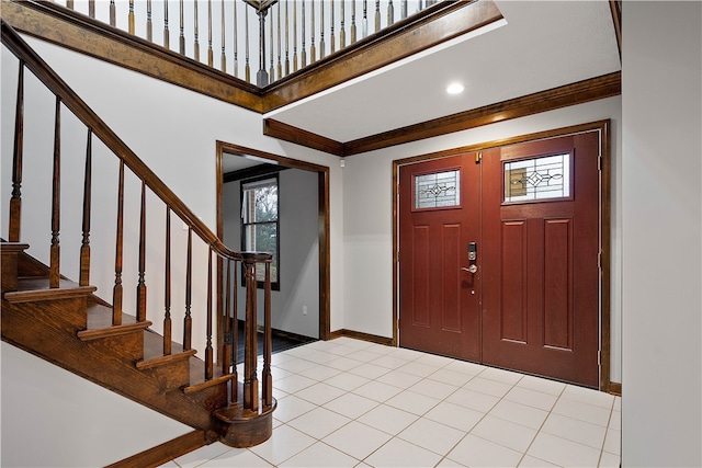 tiled foyer entrance with ornamental molding