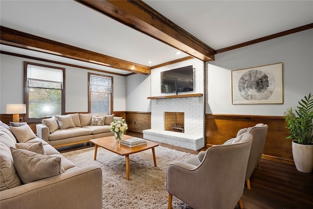 living room featuring ornamental molding, wooden walls, beam ceiling, a fireplace, and hardwood / wood-style floors