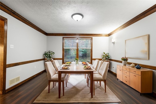 dining space featuring a textured ceiling, crown molding, and dark hardwood / wood-style floors