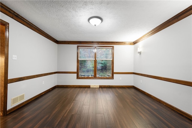 spare room with crown molding, dark wood-type flooring, and a textured ceiling