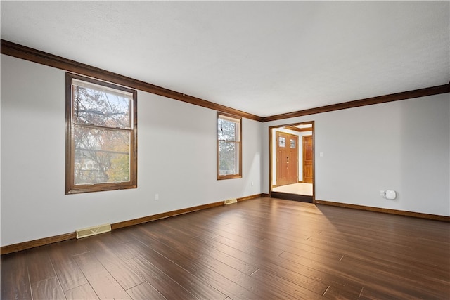 unfurnished room featuring dark hardwood / wood-style floors and ornamental molding