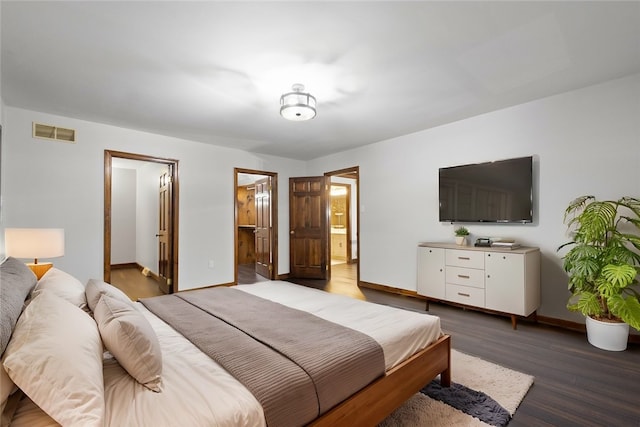 bedroom featuring hardwood / wood-style floors and ensuite bath