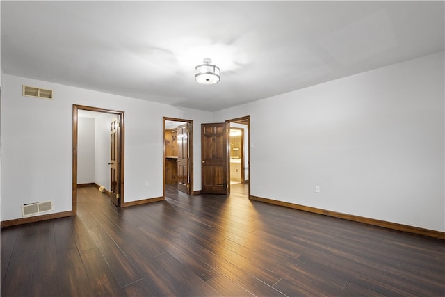 empty room featuring dark hardwood / wood-style flooring