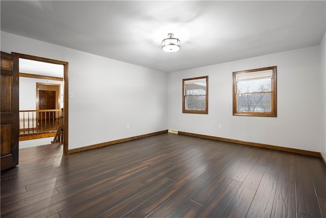 empty room featuring dark hardwood / wood-style flooring