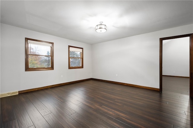 spare room featuring dark wood-type flooring