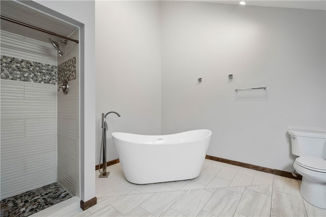 bathroom featuring toilet and independent shower and bath