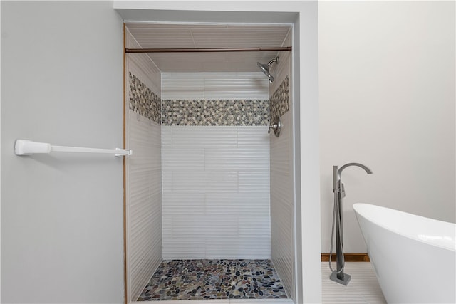 bathroom featuring tile patterned flooring and independent shower and bath