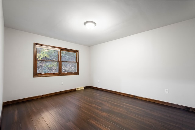 spare room with dark hardwood / wood-style floors